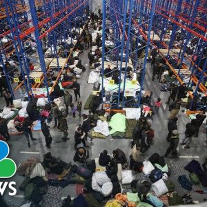 Migrants Swap Makeshift Forest Camp For Warehouse